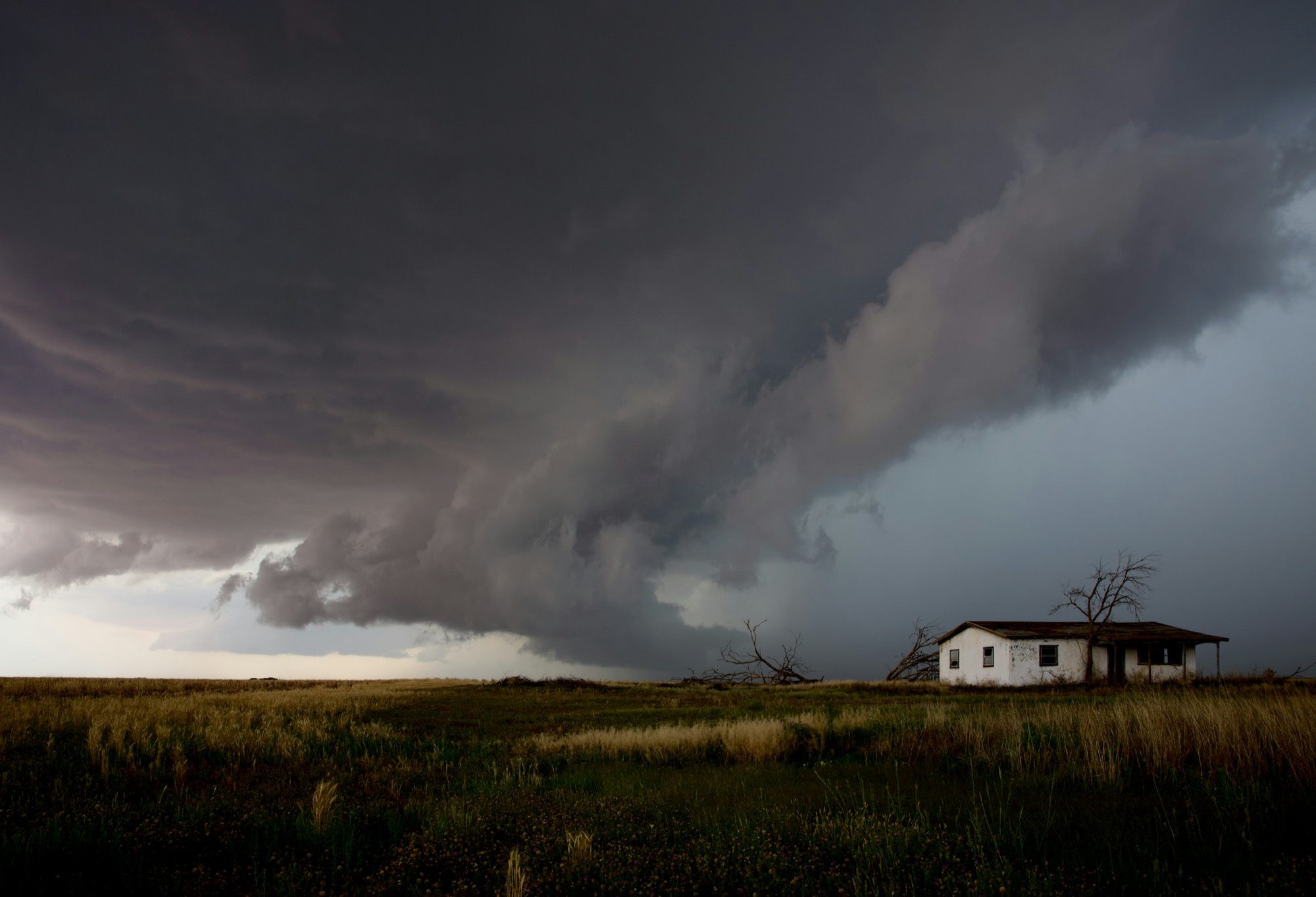 Texas home and storm clouds representing property claim preparedness